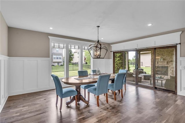 25203 W 97th Ter, Lenexa, KS 66227 - dining area with a decorative wall, plenty of natural light, a wainscoted wall, a chandelier, and recessed lighting