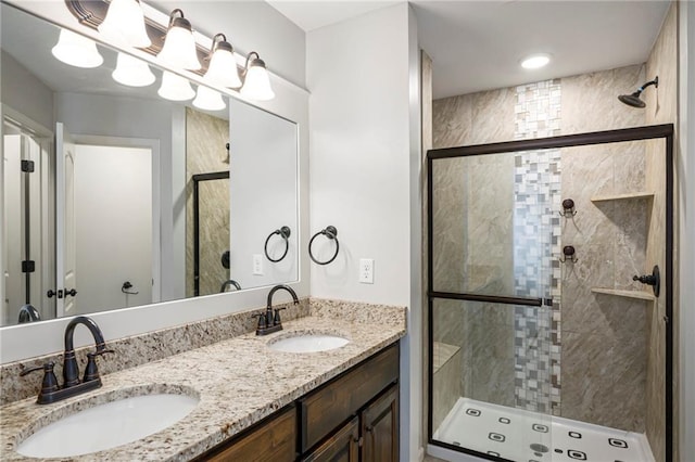bathroom with a sink and a shower stall