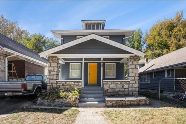 2922 Bales Ave, Kansas City, MO 64128 - traditional style home featuring covered porch and stone siding