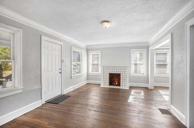 2922 Bales Ave, Kansas City, MO 64128 - unfurnished living room featuring ornamental molding, a textured ceiling, and dark wood-style flooring