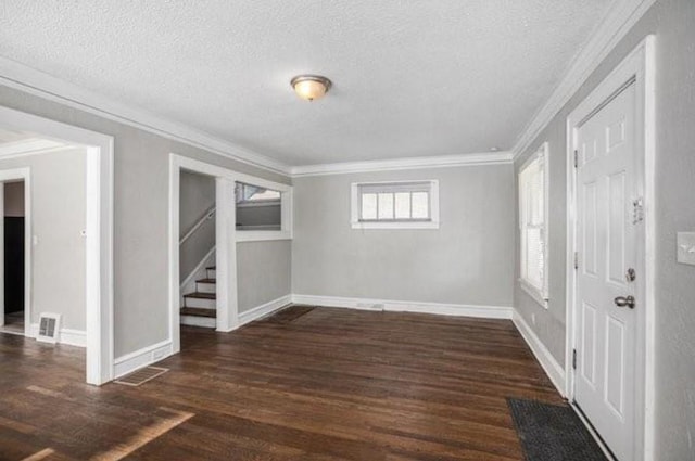 2922 Bales Ave, Kansas City, MO 64128 - entrance foyer featuring stairway, dark wood-type flooring, visible vents, ornamental molding, and a textured ceiling
