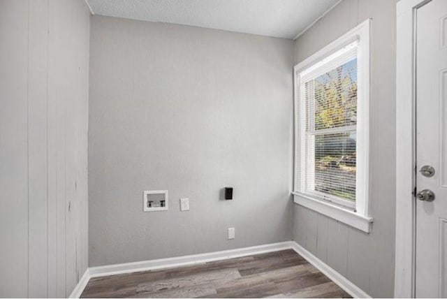 2922 Bales Ave, Kansas City, MO 64128 - laundry room featuring hookup for a washing machine, wood finished floors, laundry area, and plenty of natural light
