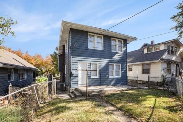 2922 Bales Ave, Kansas City, MO 64128 - back of house featuring a lawn, a patio area, and a fenced backyard