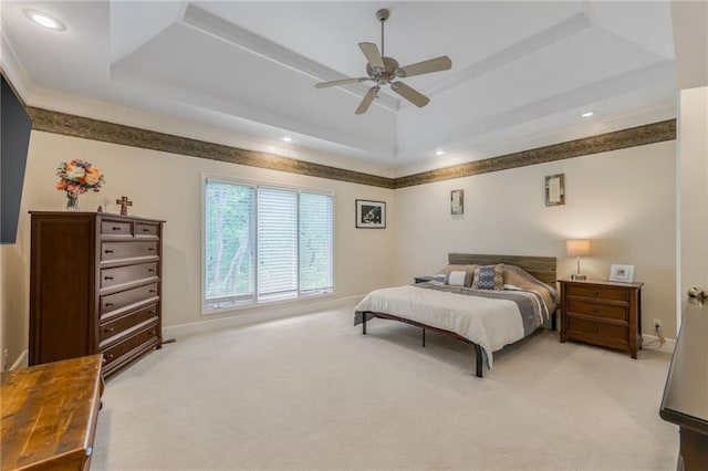 bedroom with light colored carpet, baseboards, a tray ceiling, recessed lighting, and a ceiling fan
