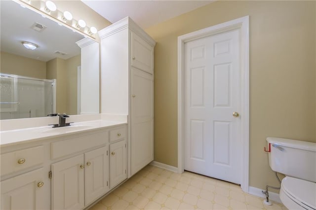 bathroom featuring tile patterned floors, toilet, baseboards, and a shower with door