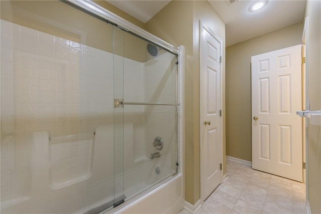 bathroom featuring baseboards, shower / bath combination with glass door, recessed lighting, and tile patterned floors