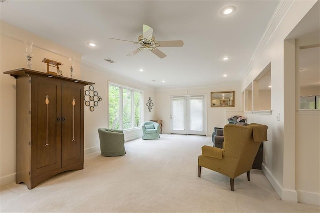 living area featuring ornamental molding, light carpet, a ceiling fan, baseboards, and recessed lighting