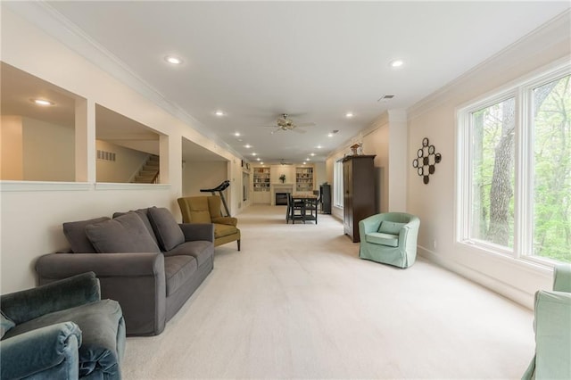 living area with light colored carpet, crown molding, ceiling fan, recessed lighting, and healthy amount of natural light