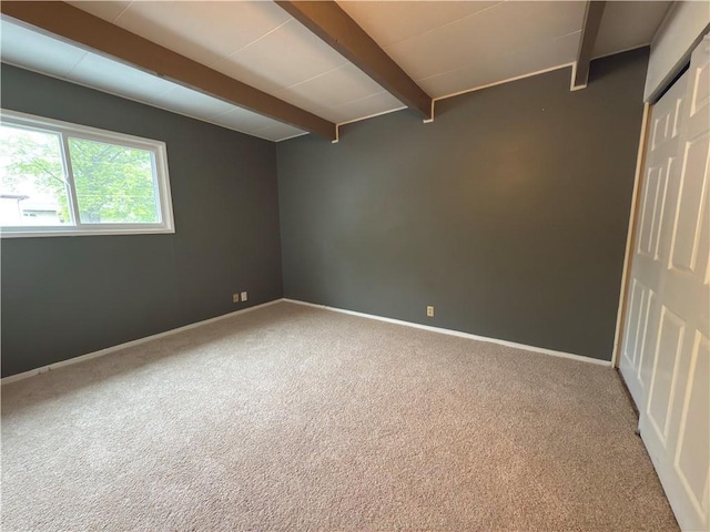 interior space with baseboards and beamed ceiling