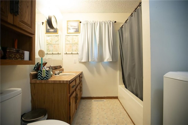 bathroom with vanity, shower / bath combination with curtain, tile patterned floors, toilet, and washer / clothes dryer