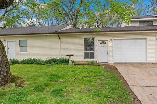 view of front of house with a front yard, driveway, and a garage