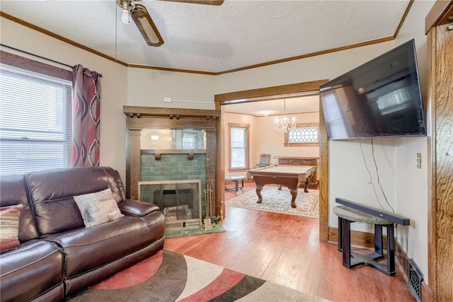 living area featuring a textured ceiling, wood finished floors, billiards, and a ceiling fan