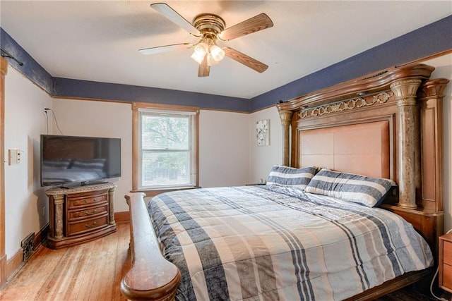 bedroom featuring a ceiling fan, wood finished floors, and baseboards