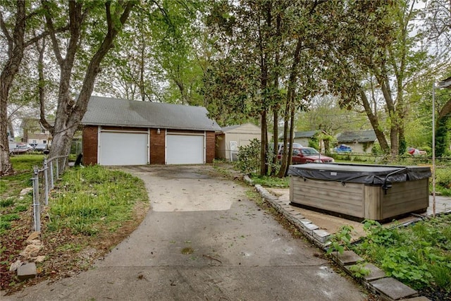exterior space with fence and concrete driveway