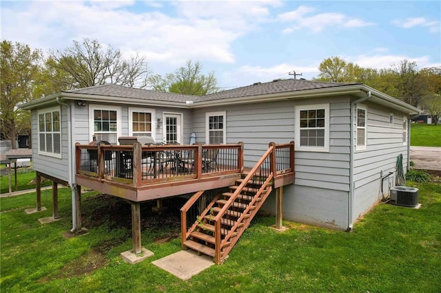 back of house featuring a lawn, a deck, and central AC