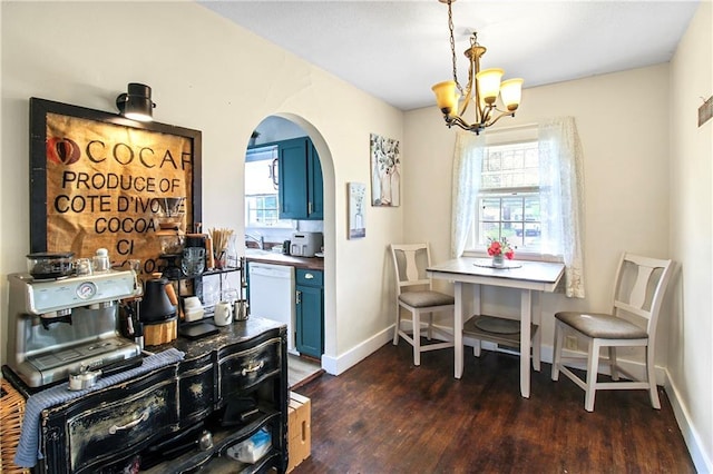 dining space featuring a chandelier, arched walkways, a healthy amount of sunlight, and dark wood-type flooring