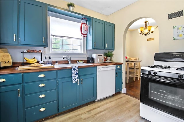 kitchen featuring a sink, gas stove, arched walkways, dishwasher, and butcher block counters