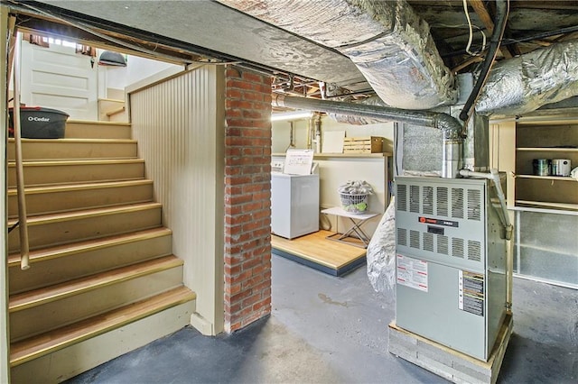 unfinished below grade area featuring washer / dryer and stairs