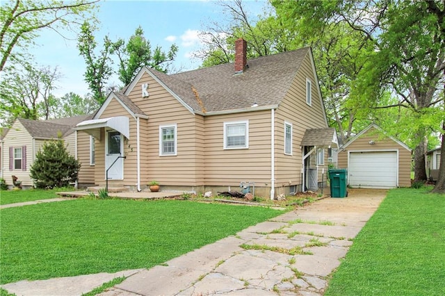 view of front of property with a chimney, an outbuilding, a detached garage, a front yard, and concrete driveway