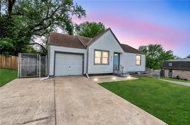 view of front of property with a lawn, driveway, an attached garage, and fence
