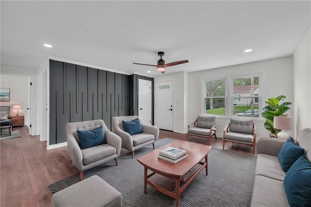 living room with ornamental molding, recessed lighting, ceiling fan, and wood finished floors