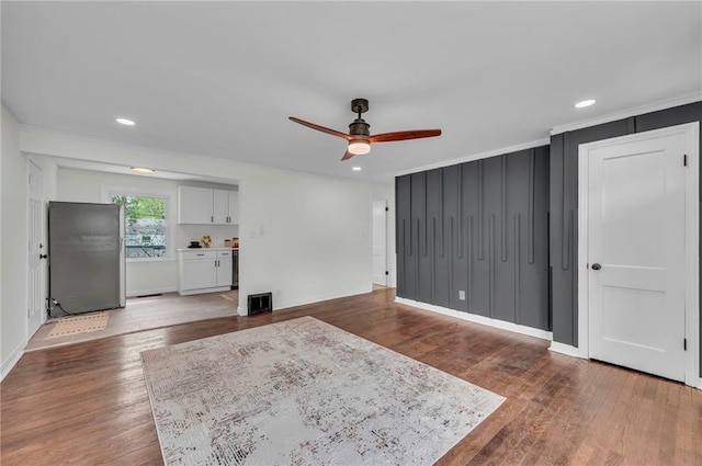 unfurnished living room featuring recessed lighting, wood finished floors, baseboards, a ceiling fan, and crown molding