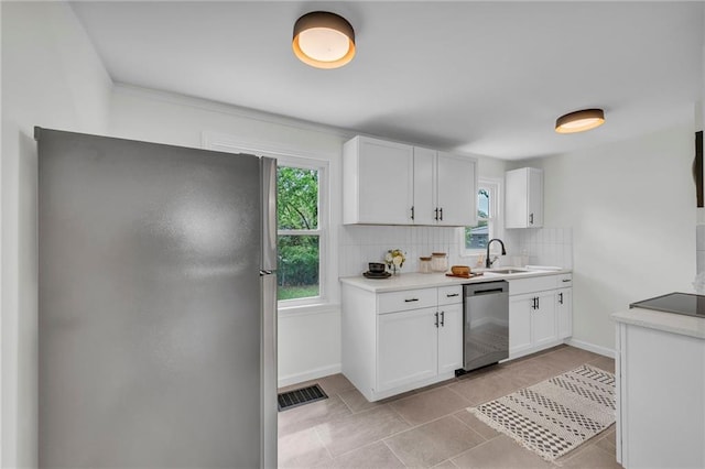 kitchen featuring light countertops, white cabinetry, stainless steel appliances, and decorative backsplash