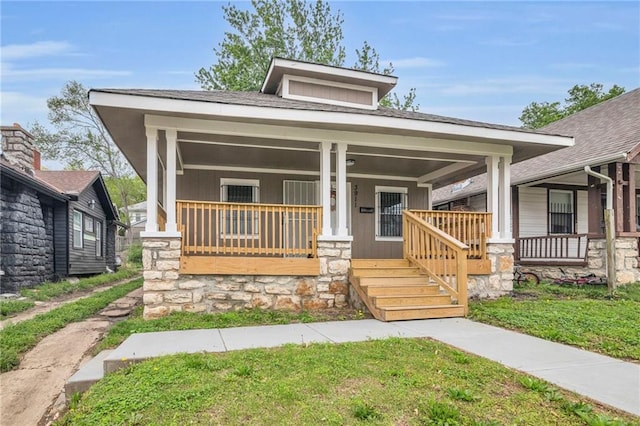 bungalow-style home featuring a porch and a front lawn