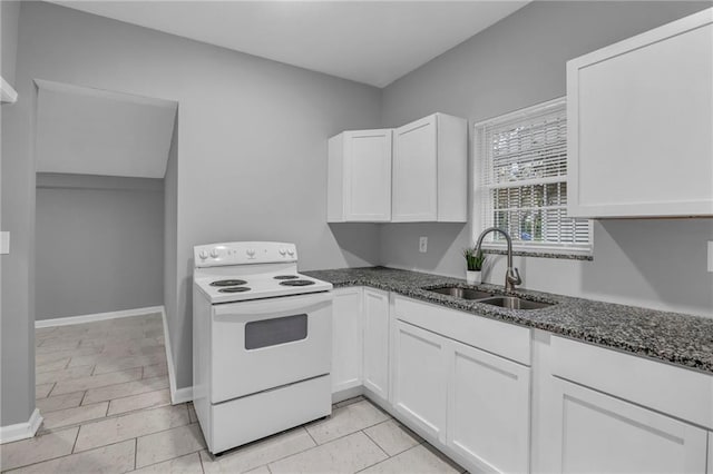 kitchen with electric range, a sink, light tile patterned floors, dark stone countertops, and white cabinetry