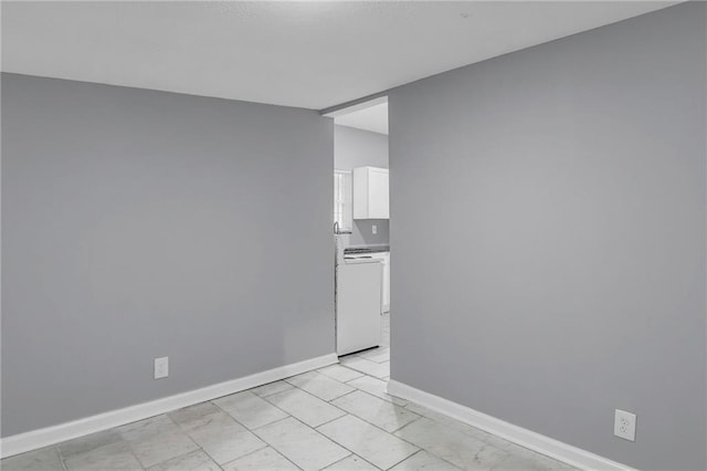 unfurnished room with baseboards and marble finish floor