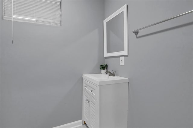 bathroom featuring baseboards and vanity