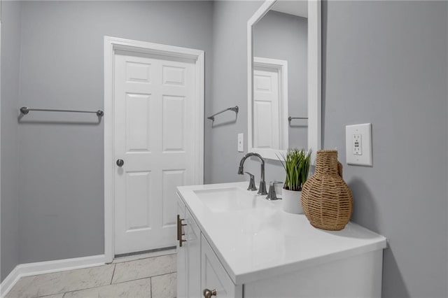 bathroom with vanity and baseboards