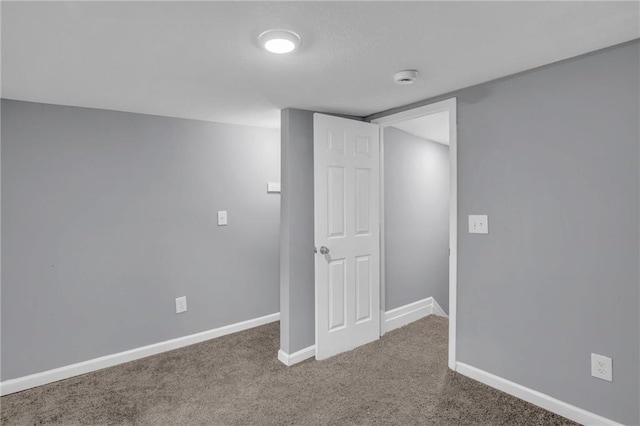 below grade area with baseboards and carpet floors
