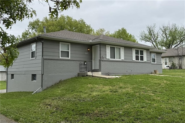 ranch-style house with brick siding and a front yard