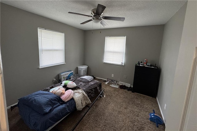 bedroom featuring a textured ceiling, ceiling fan, baseboards, and carpet floors