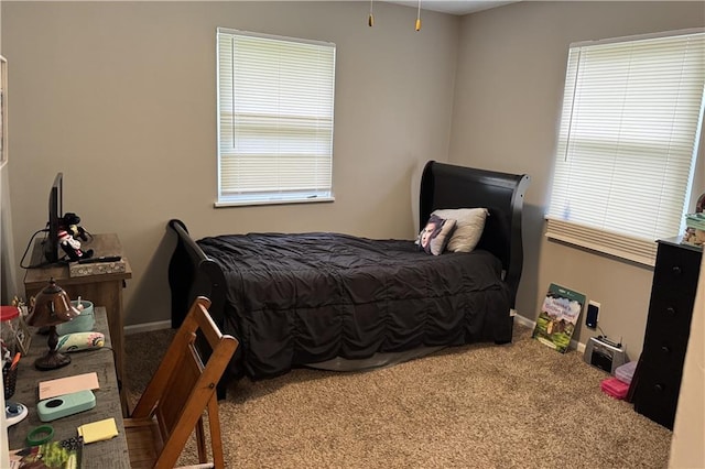 bedroom with carpet floors and baseboards