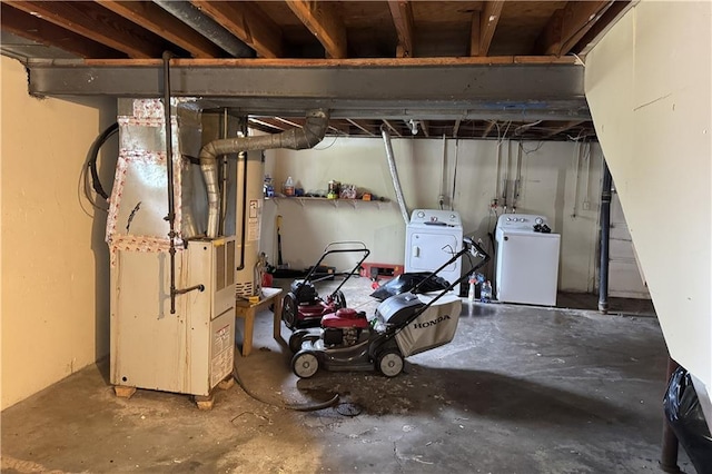 unfinished below grade area featuring washing machine and dryer and heating unit