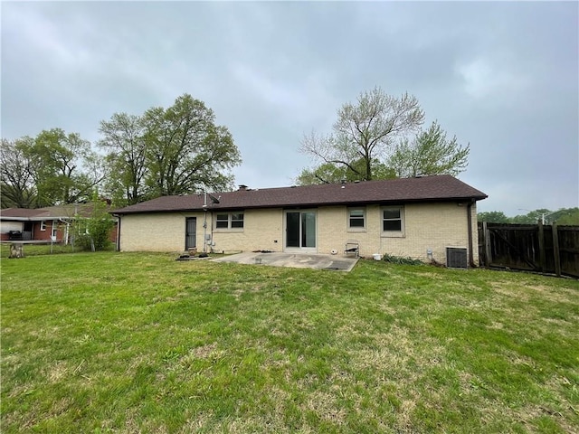 back of house with brick siding, central AC, fence, a yard, and a patio