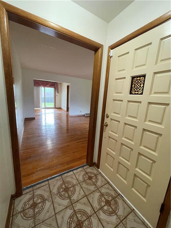 interior space with baseboards and light tile patterned floors
