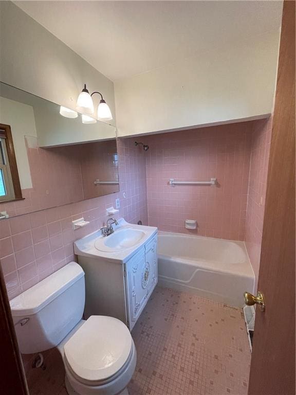full bathroom featuring toilet, shower / washtub combination, tile walls, and vanity