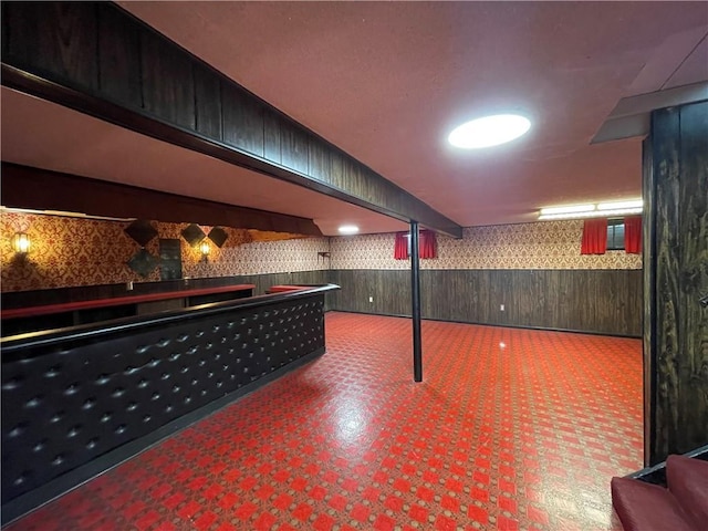 bar featuring wainscoting, tile patterned floors, wooden walls, and wallpapered walls