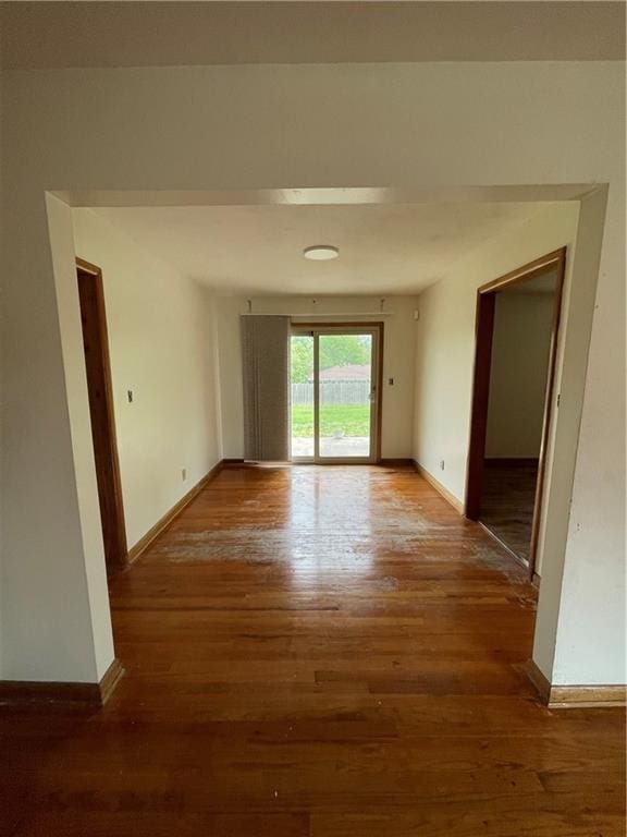 interior space with baseboards and wood finished floors