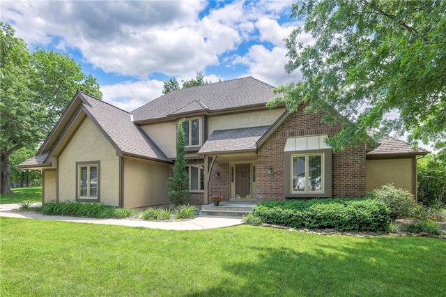 12704 Mohawk Cir, Leawood, KS 66209 - view of front facade with a front yard, stucco siding, and a shingled roof