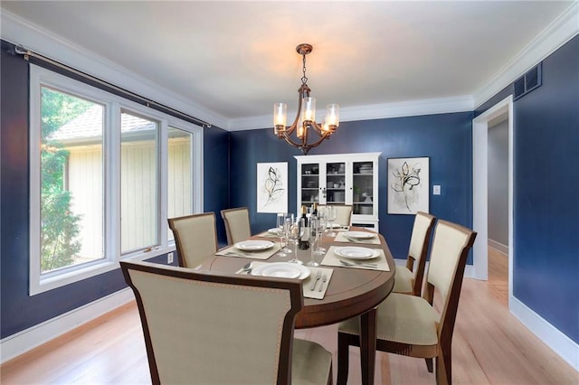 12704 Mohawk Cir, Leawood, KS 66209 - dining space featuring a chandelier, light wood finished floors, ornamental molding, and baseboards