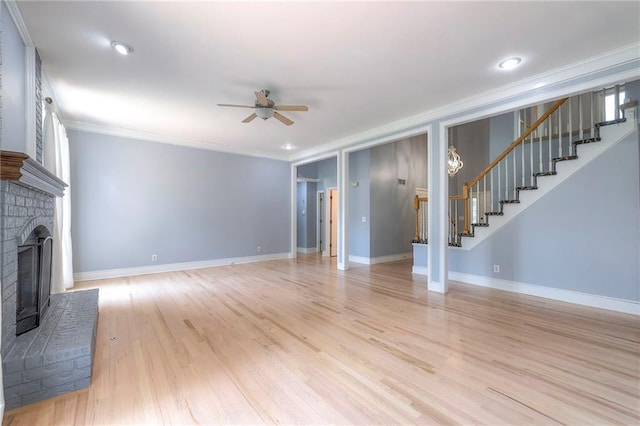 12704 Mohawk Cir, Leawood, KS 66209 - unfurnished living room with a fireplace, stairs, ceiling fan, ornamental molding, and light wood finished floors