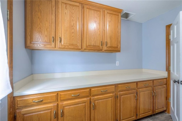 12704 Mohawk Cir, Leawood, KS 66209 - kitchen with brown cabinets and light countertops