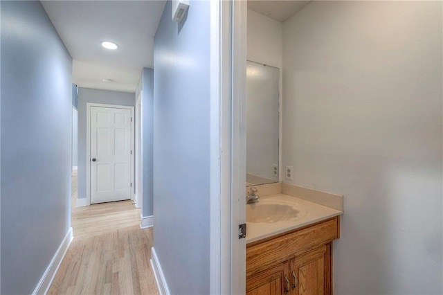 12704 Mohawk Cir, Leawood, KS 66209 - bathroom with vanity, wood finished floors, baseboards, and recessed lighting