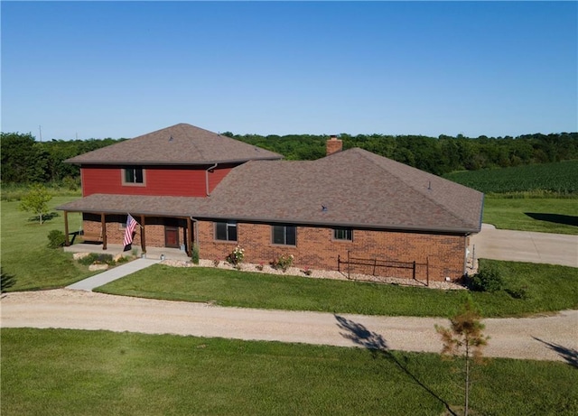 205 N 1700th Rd, Lecompton, KS 66050 - view of front of home featuring driveway, a front yard, a chimney, a porch, and brick siding