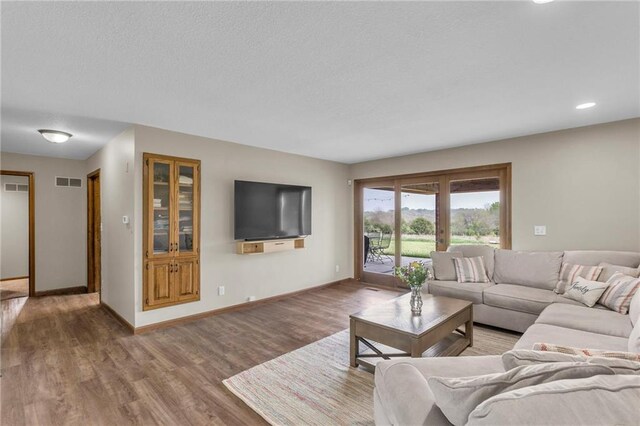 205 N 1700th Rd, Lecompton, KS 66050 - living room with wood finished floors, baseboards, recessed lighting, a textured ceiling, and french doors