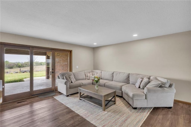 205 N 1700th Rd, Lecompton, KS 66050 - living area with wood finished floors, a textured ceiling, recessed lighting, and french doors